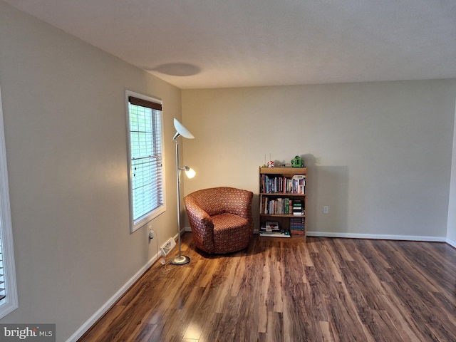 sitting room featuring baseboards and wood finished floors