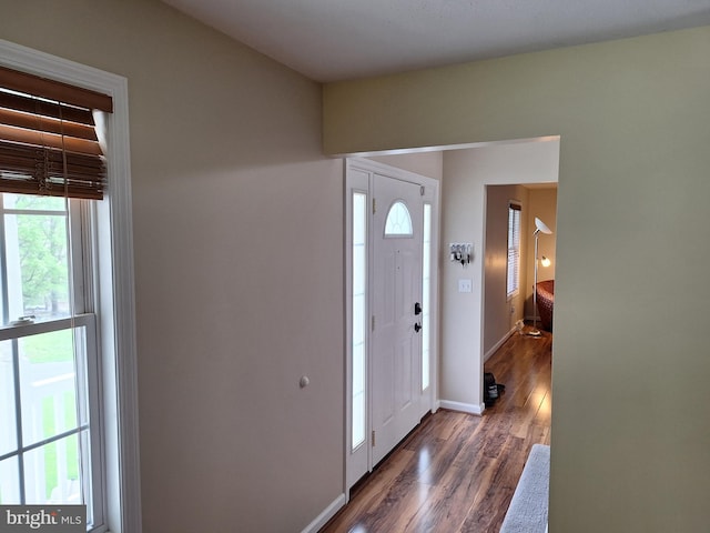 entryway with baseboards and dark wood-style floors