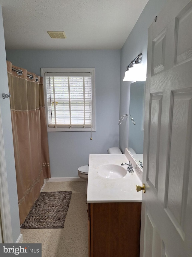 bathroom with visible vents, vanity, curtained shower, toilet, and baseboards