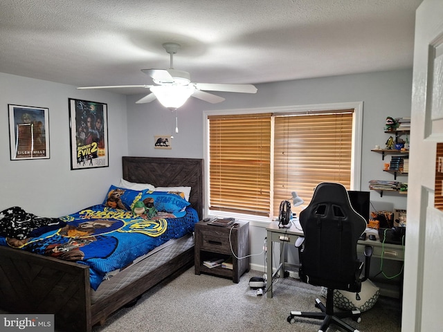 carpeted bedroom with ceiling fan and baseboards