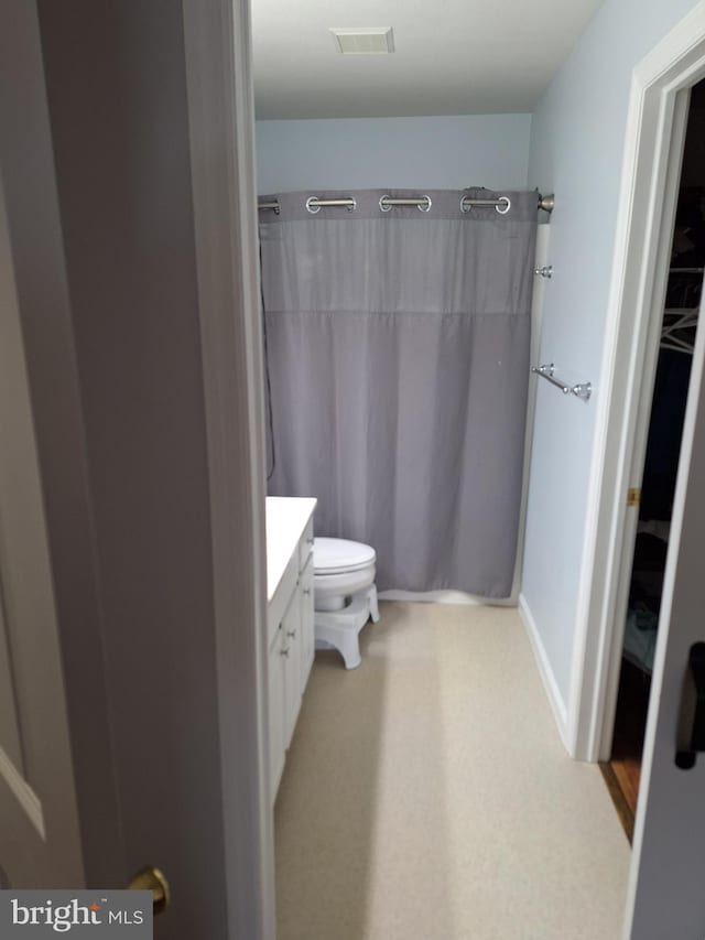 full bathroom with toilet, visible vents, curtained shower, and vanity
