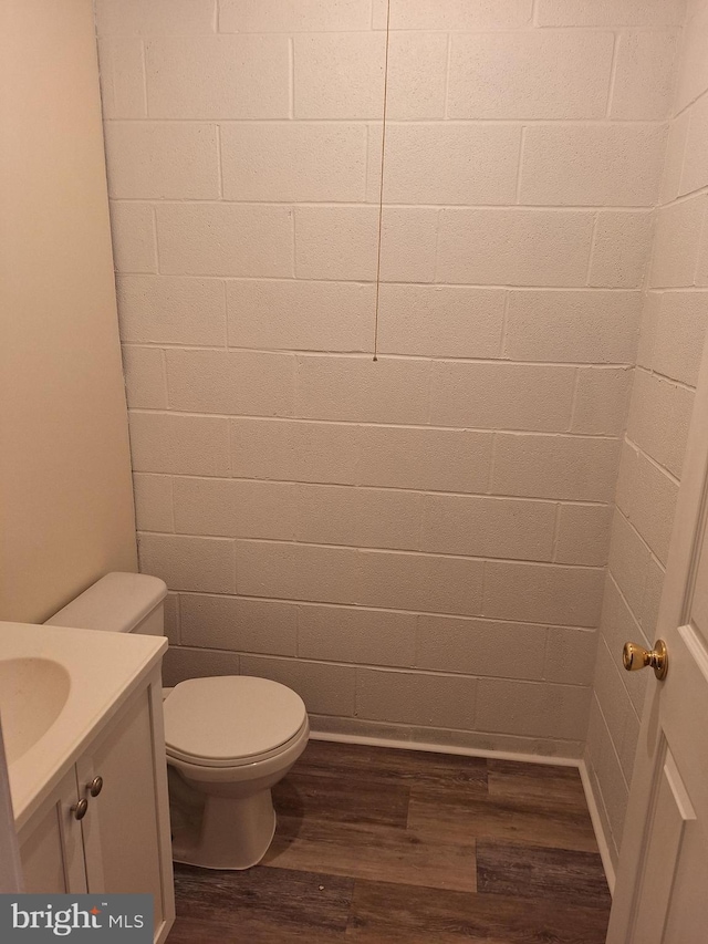 bathroom with vanity, wood finished floors, and toilet