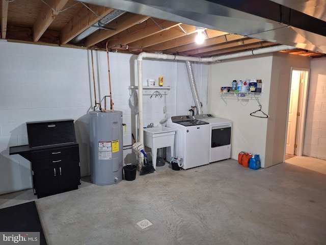unfinished below grade area with a sink, water heater, washing machine and dryer, and concrete block wall