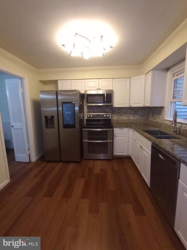 12724 Inverness Way, Woodbridge, VA 22192 - kitchen with appliances with stainless steel finishes, white cabinets, dark wood finished floors, backsplash, and dark stone counters