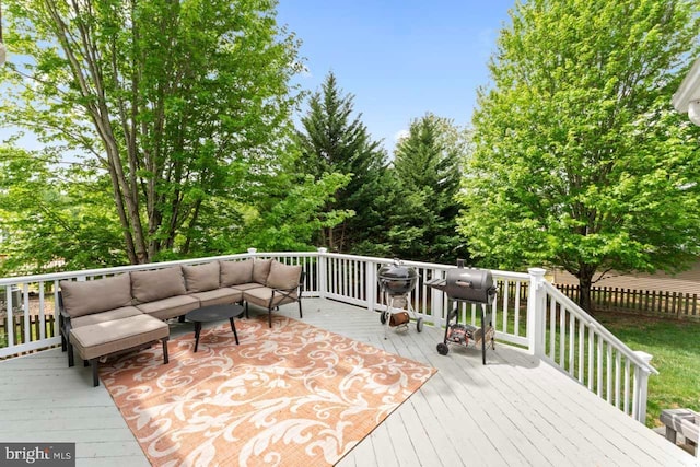 wooden deck featuring outdoor lounge area and fence