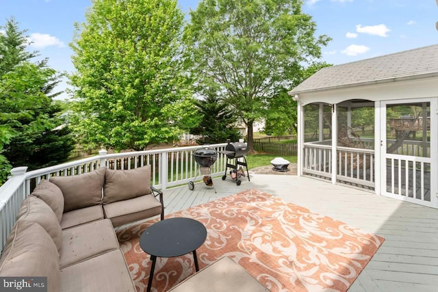 wooden deck with fence and an outdoor hangout area
