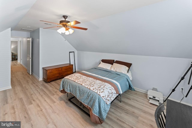 bedroom with wood finished floors, ceiling fan, vaulted ceiling, and baseboards