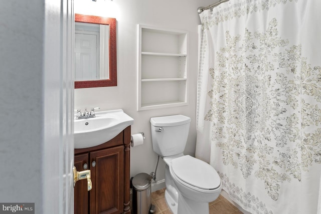 bathroom featuring curtained shower, toilet, tile patterned floors, vanity, and built in features