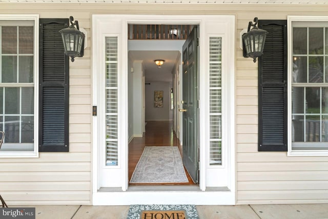 view of exterior entry featuring covered porch