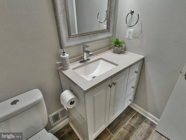 8362 Inspiration Ave, Walkersville, MD 21793 - half bath with wood finished floors, visible vents, vanity, and toilet