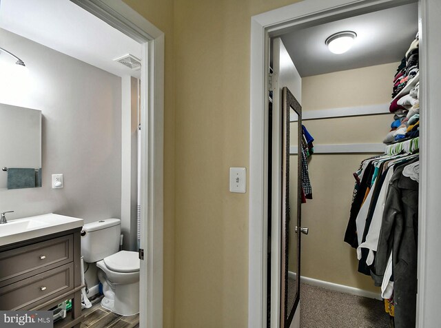 8362 Inspiration Ave, Walkersville, MD 21793 - bathroom featuring a spacious closet, wood finished floors, visible vents, toilet, and vanity