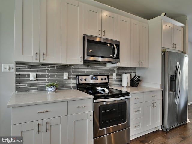 8362 Inspiration Ave, Walkersville, MD 21793 - kitchen with decorative backsplash, white cabinetry, dark wood-type flooring, and appliances with stainless steel finishes