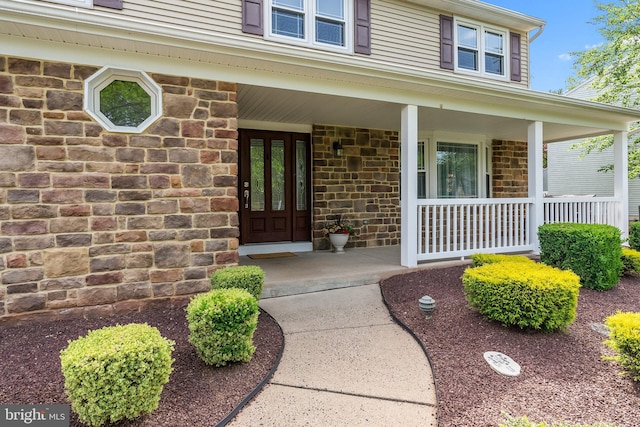 view of exterior entry featuring a porch