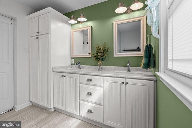 full bath featuring double vanity and a sink