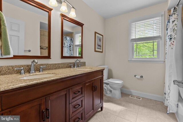 bathroom with baseboards, tile patterned flooring, visible vents, and a sink
