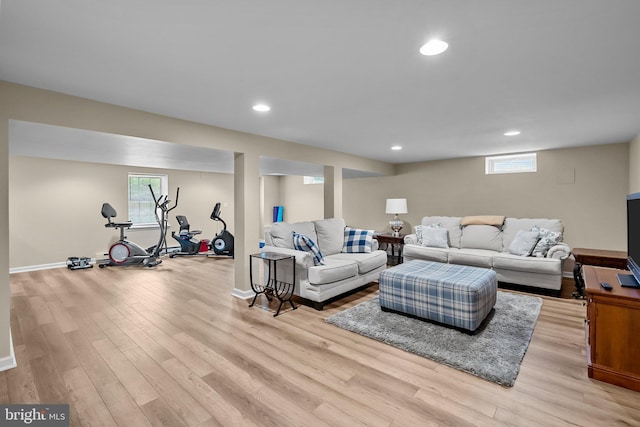 living room featuring light wood-style floors, plenty of natural light, and recessed lighting
