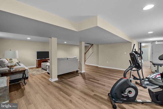 workout room featuring baseboards, recessed lighting, and wood finished floors