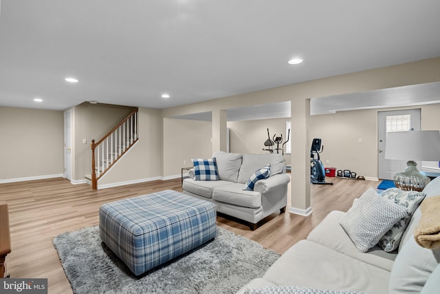 living room with baseboards, stairs, recessed lighting, and light wood-type flooring