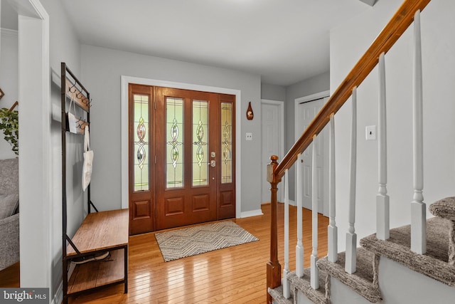 entryway featuring hardwood / wood-style flooring and stairs