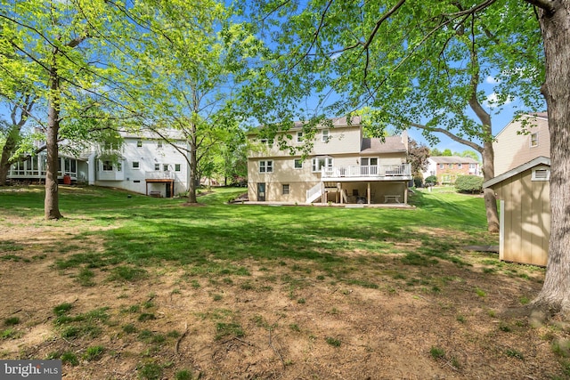 view of yard with a residential view, a wooden deck, and stairs