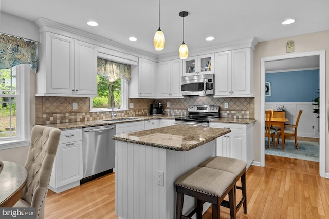 kitchen featuring white cabinets, stainless steel appliances, and a sink