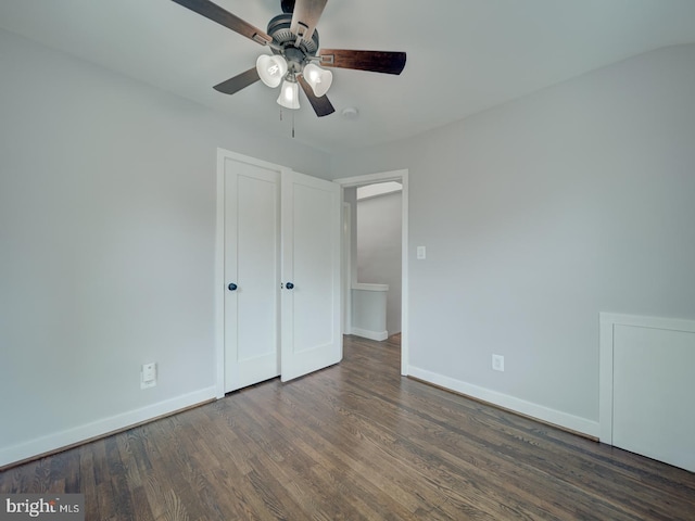 unfurnished bedroom with a ceiling fan, baseboards, and wood finished floors