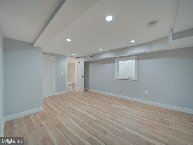 below grade area with recessed lighting, baseboards, light wood-type flooring, and visible vents