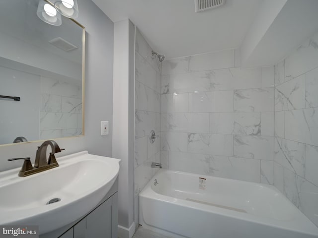 bathroom featuring visible vents, bathtub / shower combination, and vanity