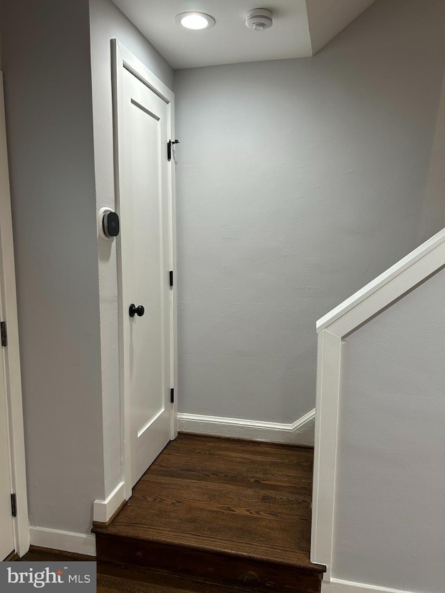 interior space with baseboards and wood finished floors