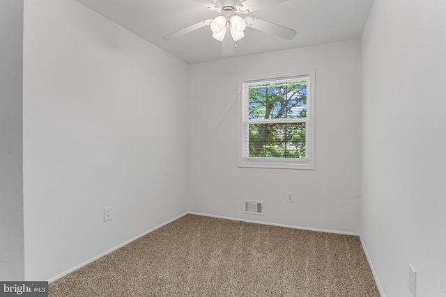 carpeted empty room featuring baseboards, a ceiling fan, and visible vents