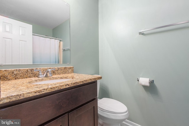bathroom featuring toilet and vanity