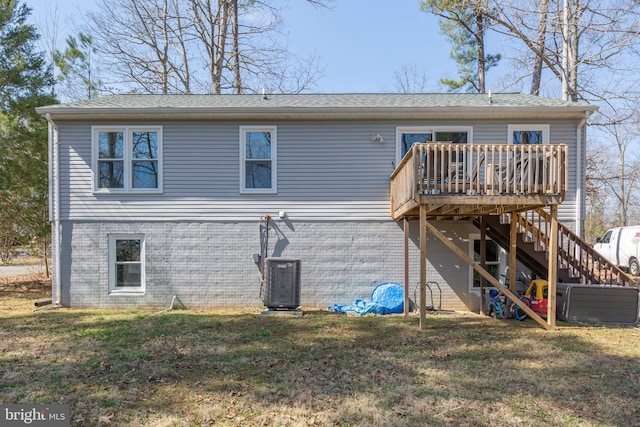 rear view of property featuring stairway, a lawn, cooling unit, and a deck