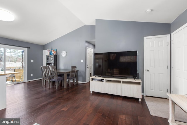 living area with lofted ceiling, baseboards, and dark wood-style floors
