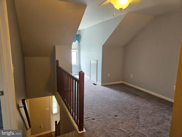 bonus room featuring ceiling fan, visible vents, baseboards, lofted ceiling, and carpet flooring