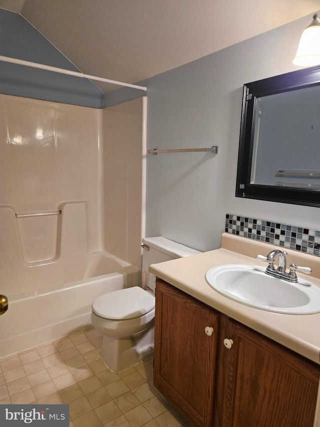 bathroom featuring backsplash, tile patterned flooring, vanity, toilet, and tub / shower combination