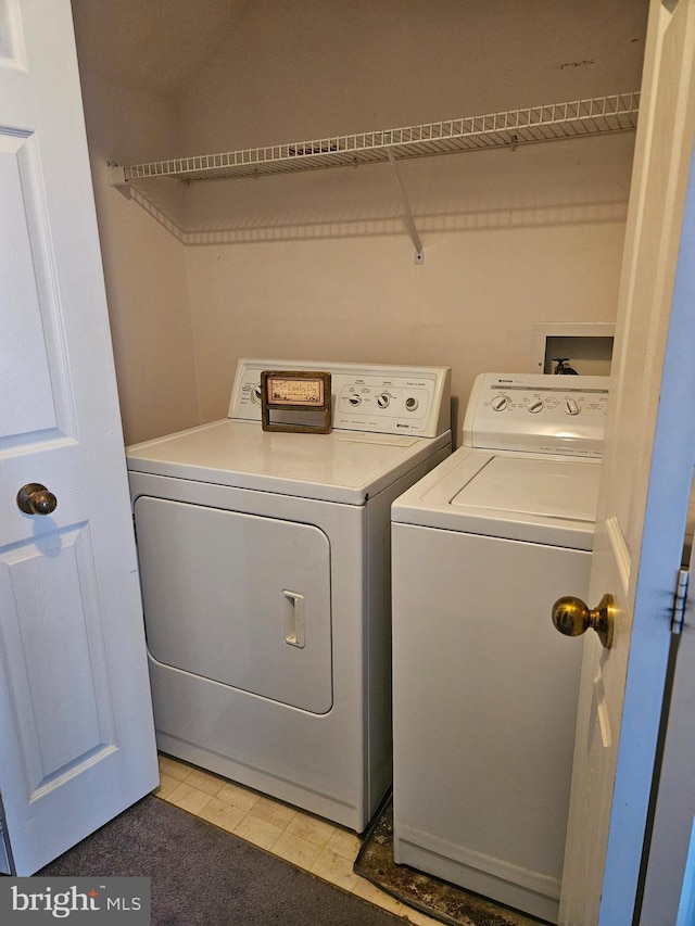 washroom featuring separate washer and dryer and laundry area