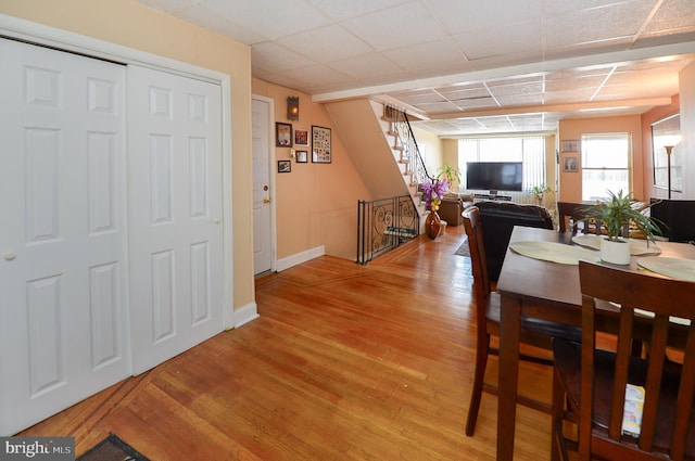dining room with stairway, baseboards, and light wood-style floors