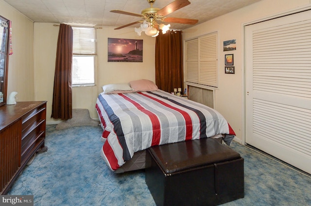 carpeted bedroom featuring two closets and ceiling fan