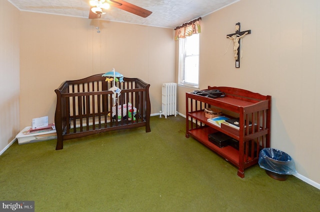 bedroom featuring a ceiling fan, baseboards, carpet floors, and radiator