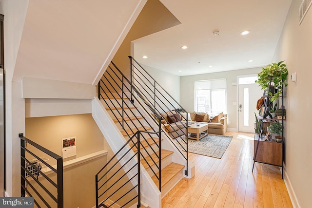 stairway with visible vents, hardwood / wood-style flooring, recessed lighting, and baseboards