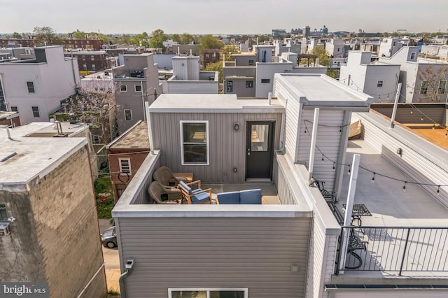 rear view of property with an outdoor living space