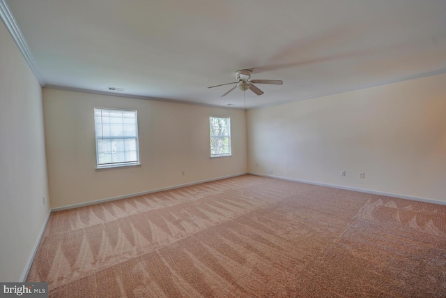 unfurnished room featuring ornamental molding, light colored carpet, and baseboards