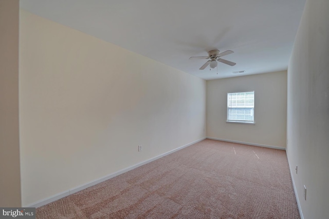 unfurnished room featuring visible vents, ceiling fan, light colored carpet, and baseboards
