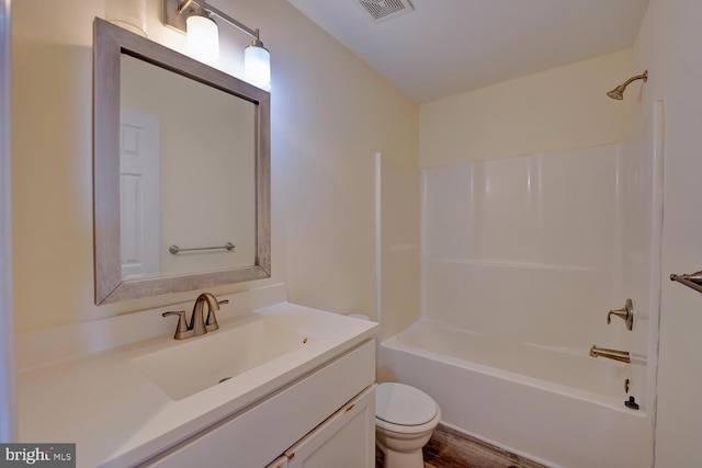 bathroom featuring visible vents, toilet, vanity, and shower / bath combination
