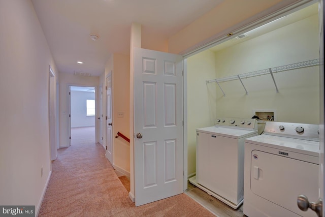 washroom featuring light colored carpet, visible vents, independent washer and dryer, and laundry area