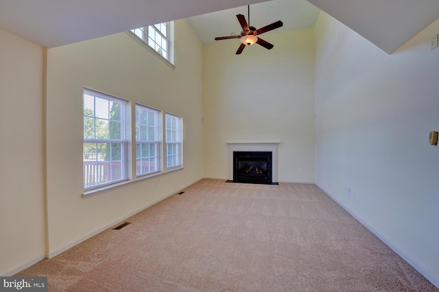 170 Otter Way, Frederica, DE 19946 - unfurnished living room featuring carpet floors, a fireplace with flush hearth, a high ceiling, and ceiling fan