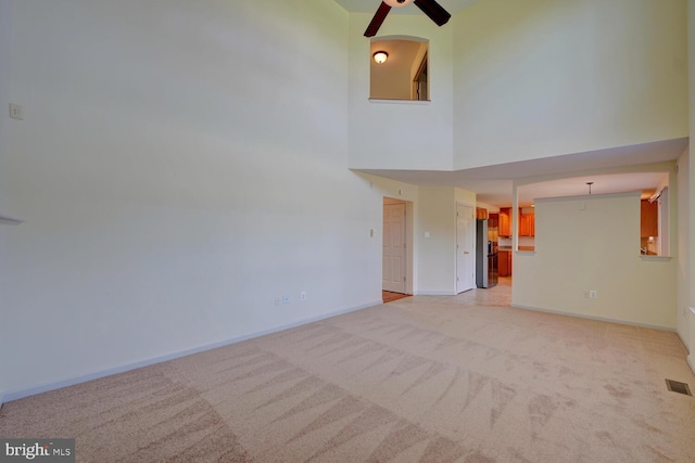 170 Otter Way, Frederica, DE 19946 - unfurnished living room featuring ceiling fan, light colored carpet, and a high ceiling