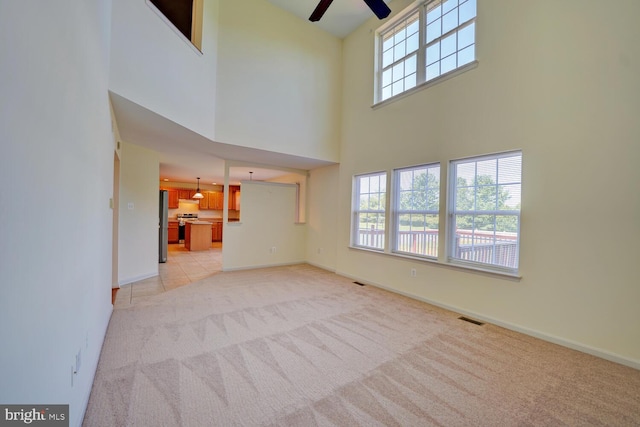 170 Otter Way, Frederica, DE 19946 - unfurnished living room featuring a towering ceiling, light carpet, and a ceiling fan