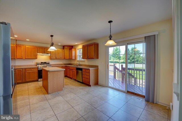 170 Otter Way, Frederica, DE 19946 - kitchen featuring stainless steel appliances, under cabinet range hood, light countertops, a kitchen island, and decorative light fixtures