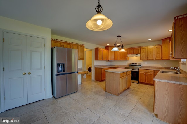 170 Otter Way, Frederica, DE 19946 - kitchen with appliances with stainless steel finishes, under cabinet range hood, washer / clothes dryer, light countertops, and light tile patterned flooring
